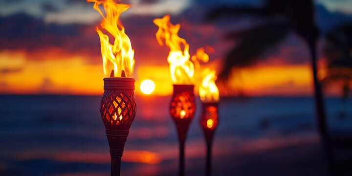 Fototapeta Hawaii luau party Maui fire tiki torches with open flames burning at sunset sky clouds at night