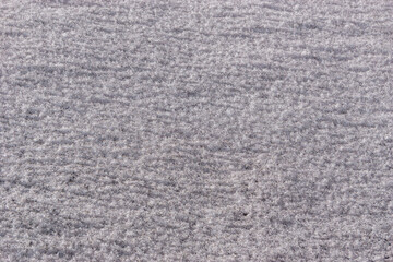 Beautiful snow background close up with small black ash particle of a volcanic eruption