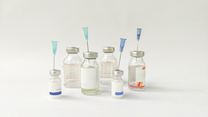 Vial of Drug or Vaccine and 3 ml Plastic Syringe with Needle Isolated on the White Background, blue tone color