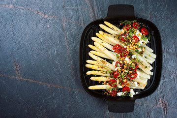 White asparagus caramelized with Greek feta cheese, tomatoes and roasted pine nuts served as top...