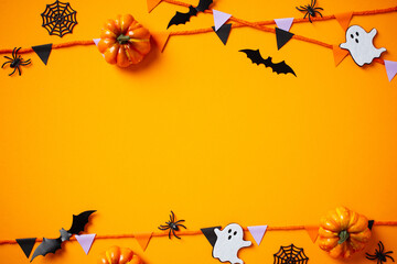 Halloween festive background featuring pumpkins, spiders, ghosts, bunting garland. Happy Halloween...