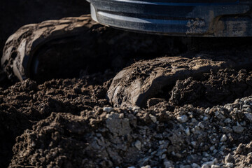Very muddy excavator tracks very deep in hard traction circumstances of building project terrain...