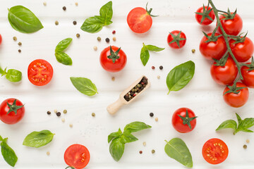 Fresh tomatoes, basil, sea salt and spices on wooden background, top view