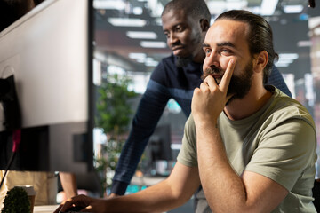 Teamworking accountants checking company document figures and stats for accuracy during job shift. Coworkers doing business tasks, crosschecking financial information in office