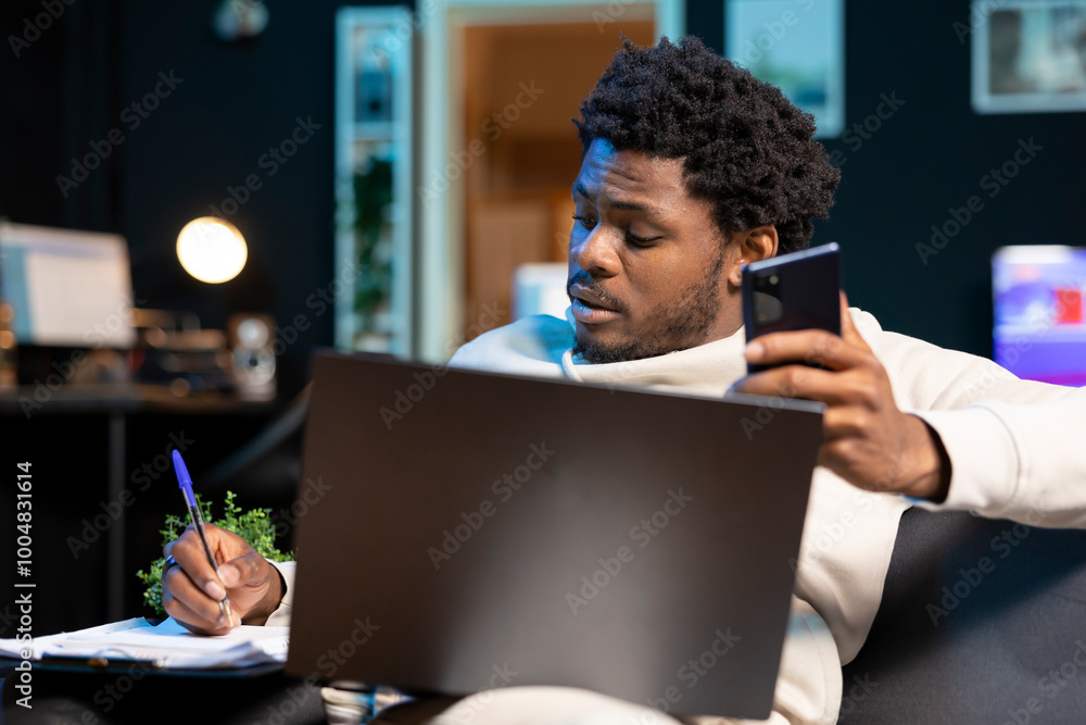 Poster self employed man working from home, writing down contact details after talking on phone with client