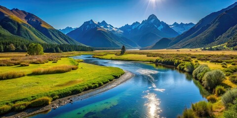 Lush Grassy River Flat Surrounded by Majestic Converging Mountains Under Clear Blue Sky