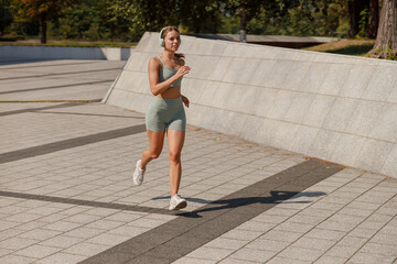 A Young Woman Jogging in an Urban Park While the Daylight Shines DownBeautifully