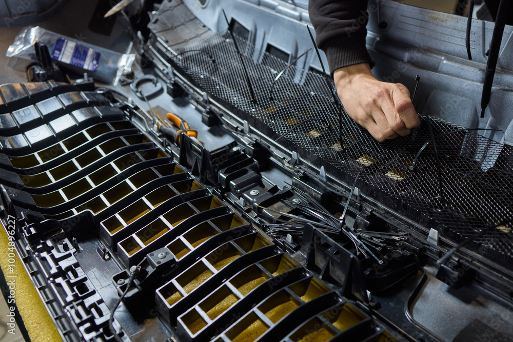 Poster hands skillfully engaged in the complex and detailed process of mechanical assembly work