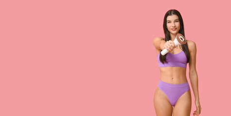 Naklejka premium Young woman holding modern photoepilator on pink background with space for text