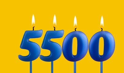 Blue candle number 5500 - Birthday on yellow background