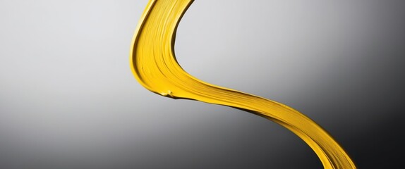 Abstract swirl of yellow oil against a smooth gradient background, representing culinary use or artistic liquid design.