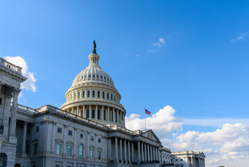 Naklejka premium The Capitol Building with Sun and Sky and the Flag