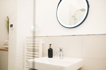 A bottle with liquid soap on the water basin
