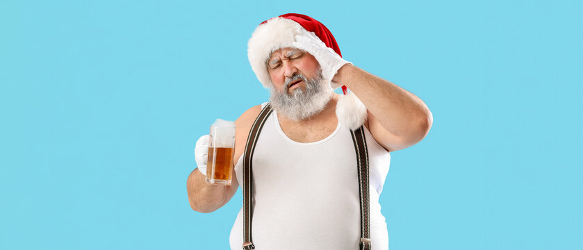 Bad Santa Claus with beer on blue background