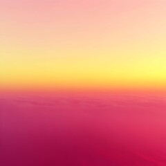 Obraz premium A beautiful sunset over the clouds, with hues of pink, orange and yellow.