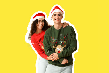 Happy young couple in Christmas sweaters on yellow background