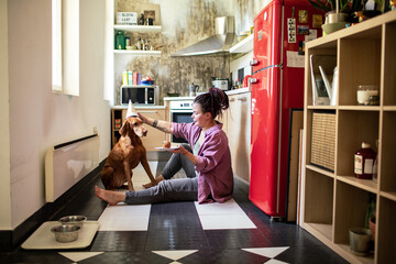 Woman celebrating dog birthday in the kitchen