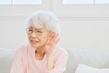 耳が遠いシニア女性　リビングルーム