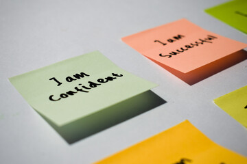 I am confident on sticky notes. Motivational words for personal development, inspirational handwriting. Isolated background