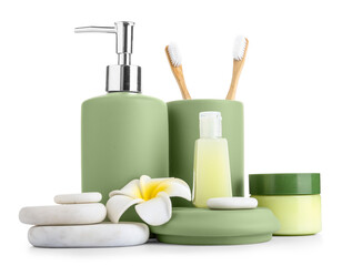 Set of bath supplies with stones and plumeria on white background