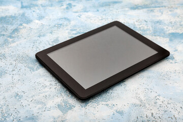 Modern tablet on grunge blue background