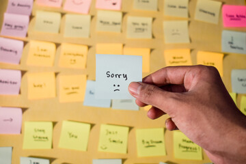 Hand hold sticky notes with words sorry, Motivational for personal development, inspirational...