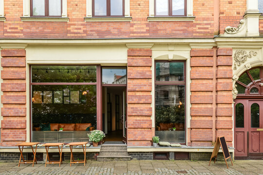 Facade of restaurant with tables on city street