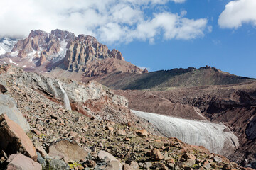 Gergeti Glacier: A vast expanse of ice descends from the mountain, carving its path through the...
