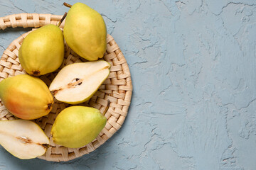 Many fresh pears on blue background