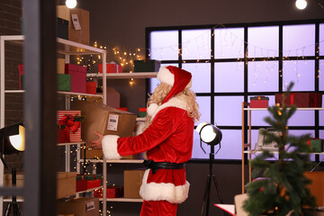 Santa Claus preparing gifts for Christmas in post office