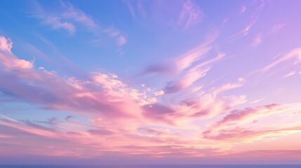 Obraz premium A peaceful sky at dusk with soft pink and purple hues, and a few wispy clouds scattered across the horizon