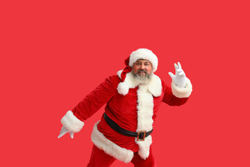 Dancing Santa Claus on red background
