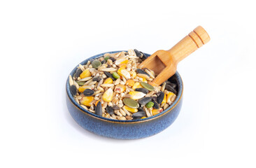 Chicken Scratch Feed with Dry Grains and Seeds Mixed in Blue Pottery Dish with Scoop