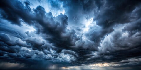 Obraz premium Dark sky with heavy clouds and faint light, ominous, atmospheric, stormy, overcast, gloomy, dramatic, moody, nature, weather