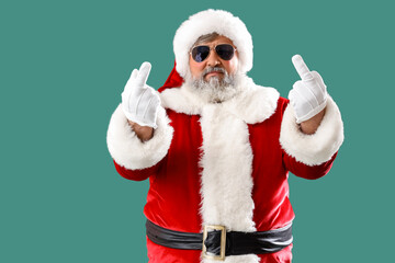 Bad Santa Claus showing middle fingers on green background