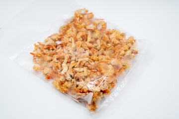 This vibrant image showcases a mound of dried shrimp, their orange hues glowing warmly against a softly lit backdrop.  Each tiny crustacean is perfectly preserved, retaining its intricate form.