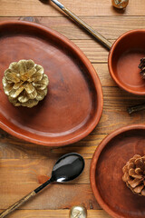 Beautiful table setting with Christmas balls and pine cones on wooden background