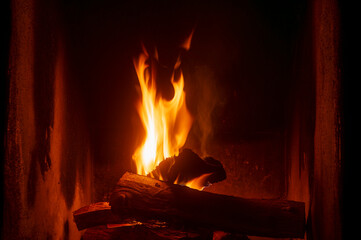 Home fireplace with red flame fire burns