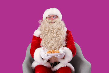 Santa Claus with tasty falafel balls on purple background
