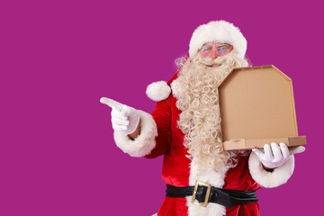 Santa Claus with box of tasty pizza pointing at something on purple background