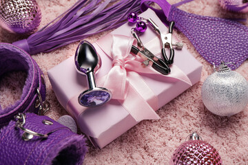 Sex toys with gift box Christmas decor on pink fluffy carpet