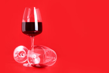 Glass of wine on red background