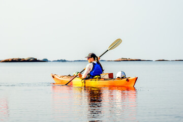 young woman paddling on a multiday sea kayak expedition on  georgian bay ontario  room for text
