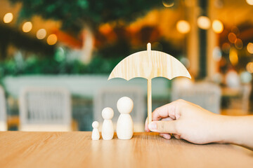 umbrella icon and family model, Security protection and health insurance. The concept of family...
