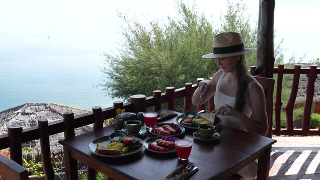 Breakfast at a hotel in Indonesia. A young woman has breakfast at a hotel in Labuan Bajo.