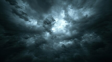 Obraz premium Dark, dramatic, stormy sky with a hint of light peeking through the clouds.