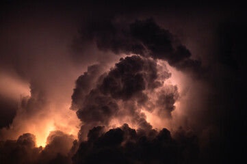Thunderstorm Dark clouds illuminated by flashes of lightning and booming thunders