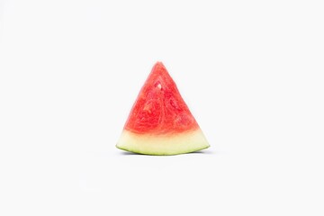 Whole watermelon and seeded slices seen front and top on a white background. Watermelon slices are red, seedy and juicy.
