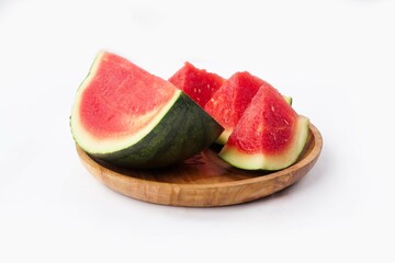 Whole watermelon and seeded slices seen front and top on a white background. Watermelon slices are red, seedy and juicy.