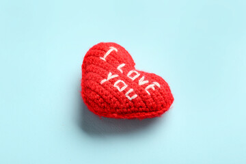 Fabric heart with text I LOVE YOU for Valentine's Day on blue background